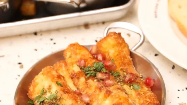 Fried halloumi sticks with pomegranate seeds and herbs at Eggstatic