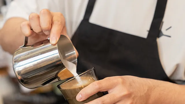 Barista pouring a latte at Eggstatic
