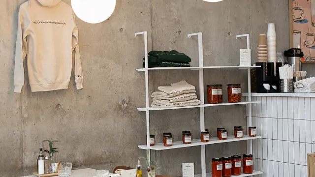 Eggstatic dining room with terrazzo tables, globe pendant lights and shelves of preserves