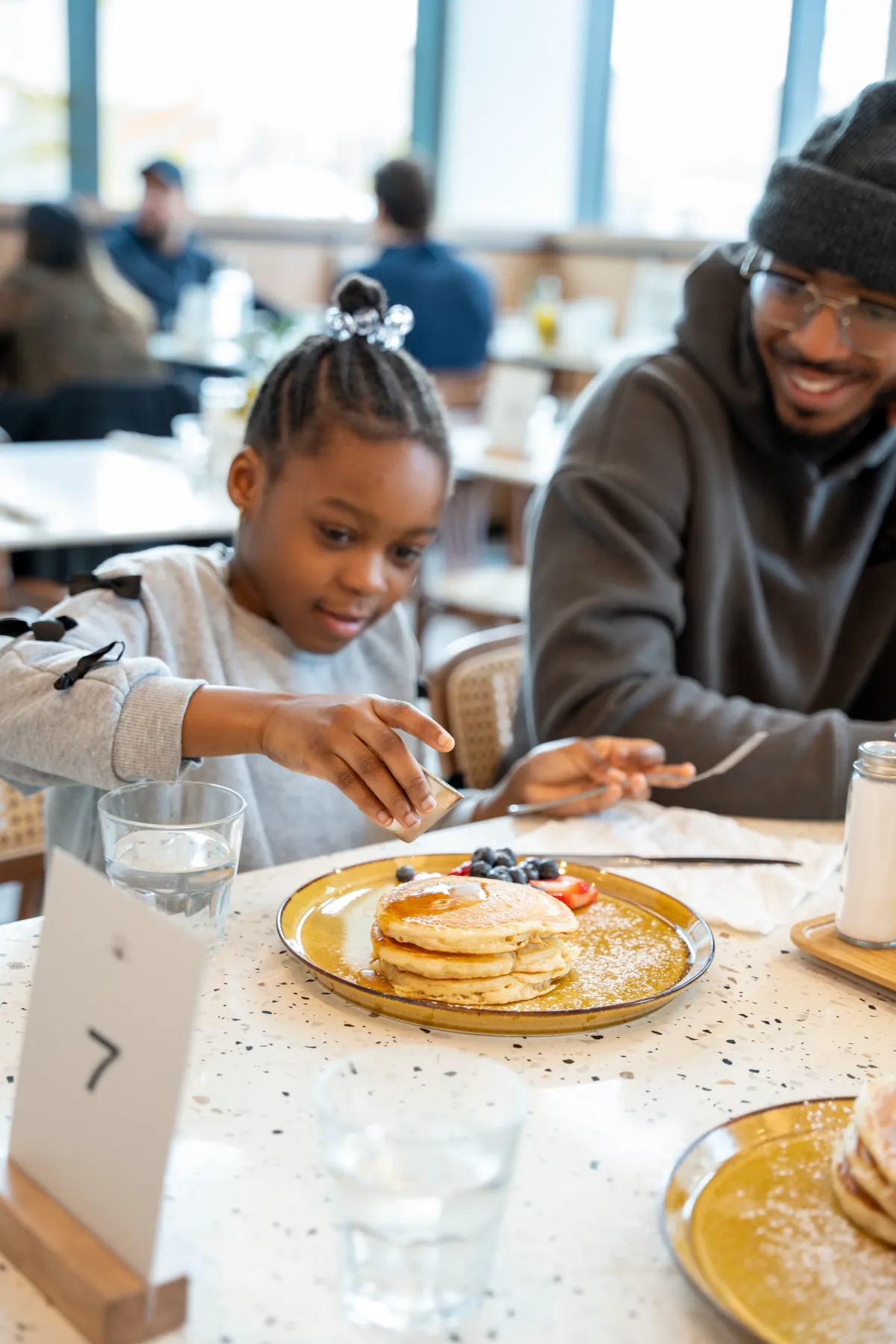 Family enjoying pancakes at an Eggstatic table