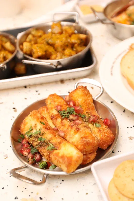 Fried halloumi sticks with pomegranate seeds and herbs at Eggstatic