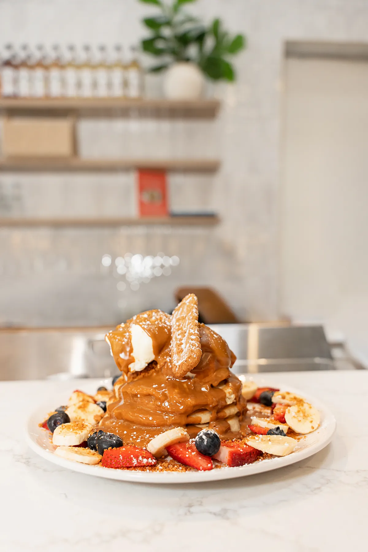 Lotus Biscoff pancake stack with banana and berries at Eggstatic