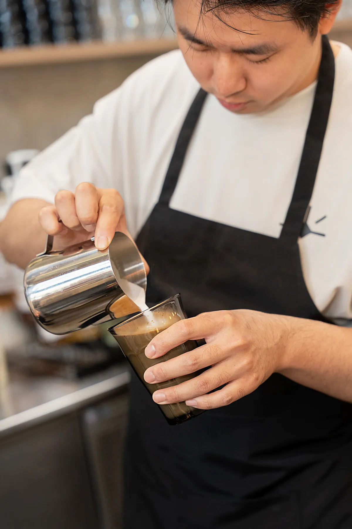 Barista pouring a latte at Eggstatic
