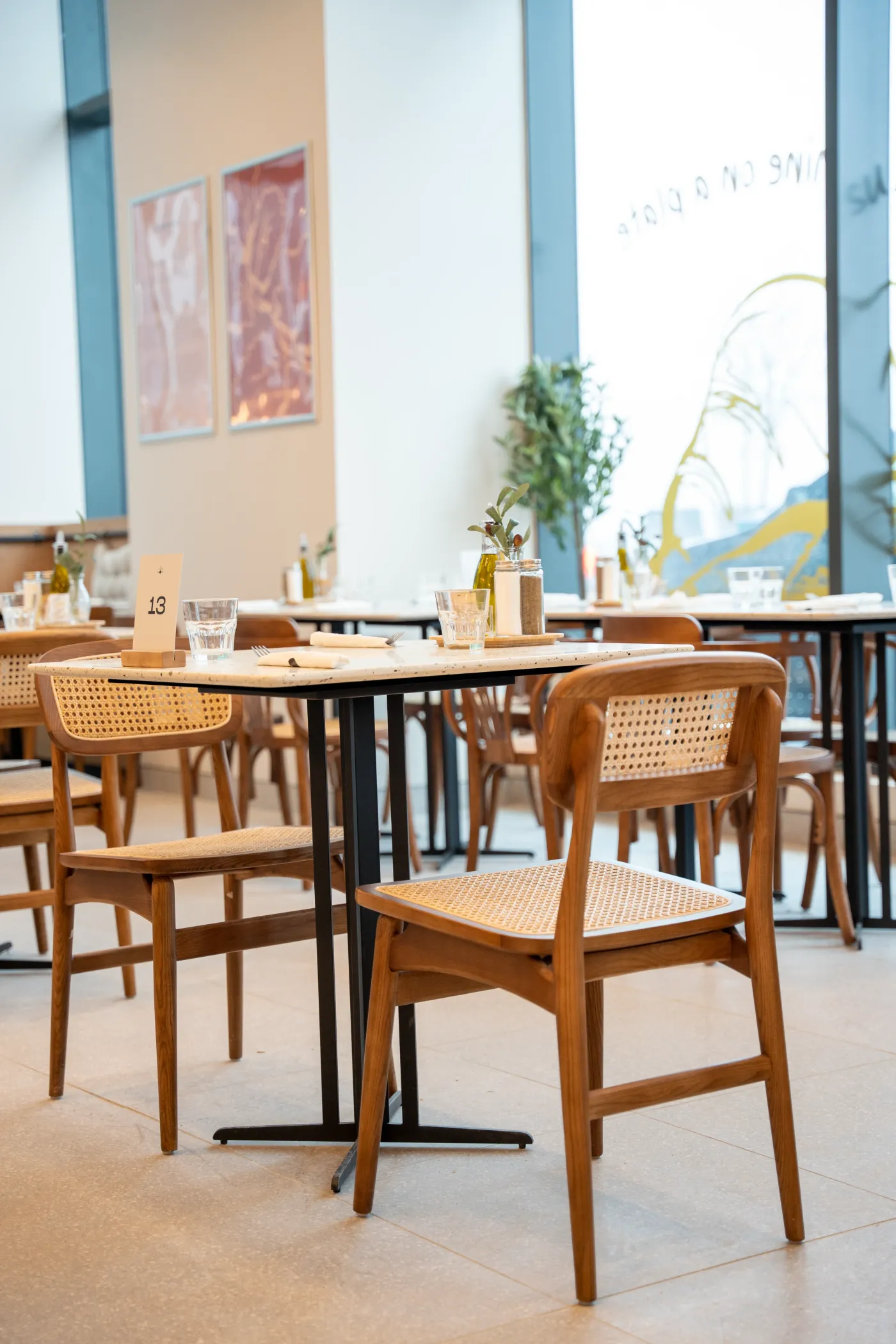 Eggstatic dining room with cane chairs and abstract wall art