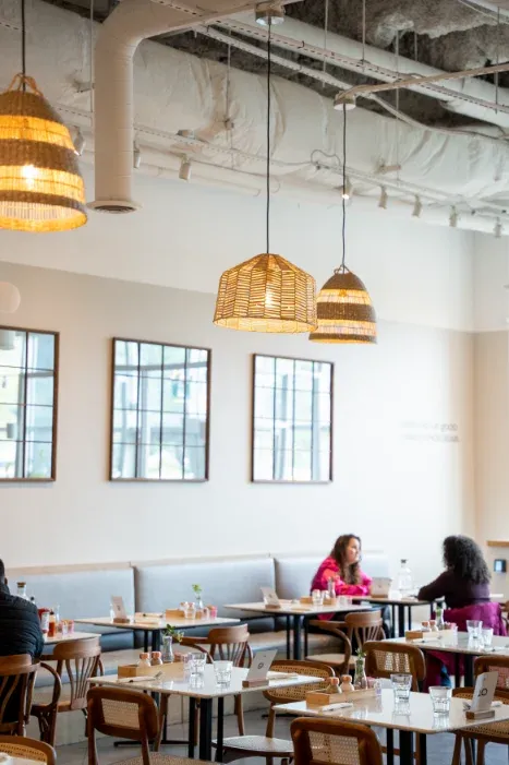 Eggstatic Scarborough dining area with woven pendants and framed window art