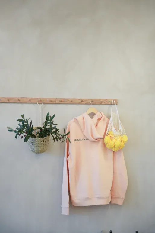 Eggstatic "Proudly a Morning Person" hoodies and lemon-filled mesh bag merch wall at Waterdown