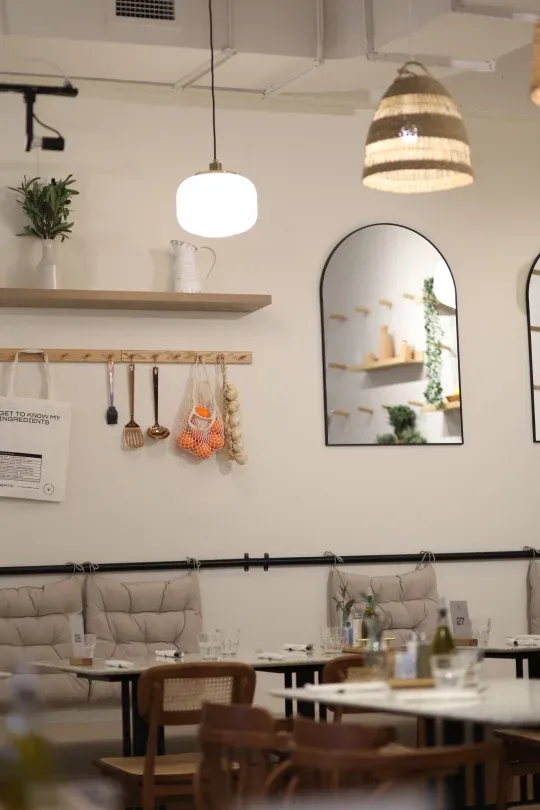 Eggstatic Montreal dining area with arched mirrors, hanging utensils and banquette seating