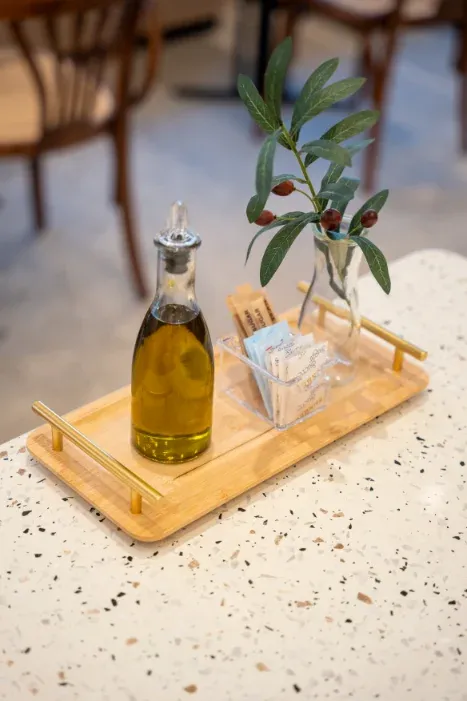 Olive-oil bottle and condiments caddy on a terrazzo table at Eggstatic Oakville