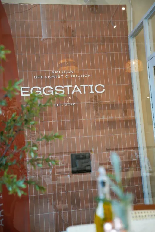 Eggstatic "Artisan Breakfast & Brunch — Est. 2018" terracotta-tile signage at Waterdown