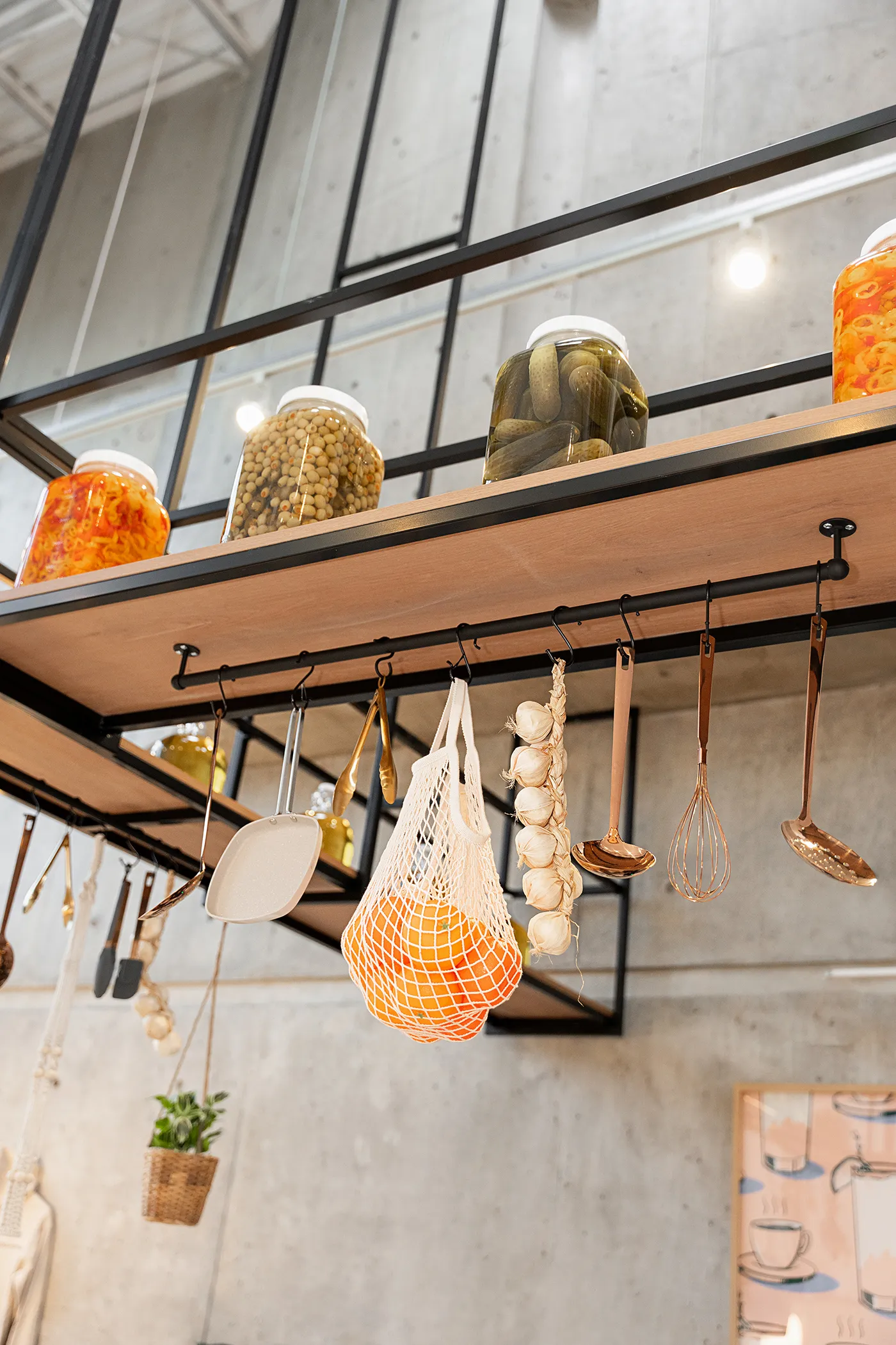 Eggstatic overhead shelf with preserve jars and hanging utensils