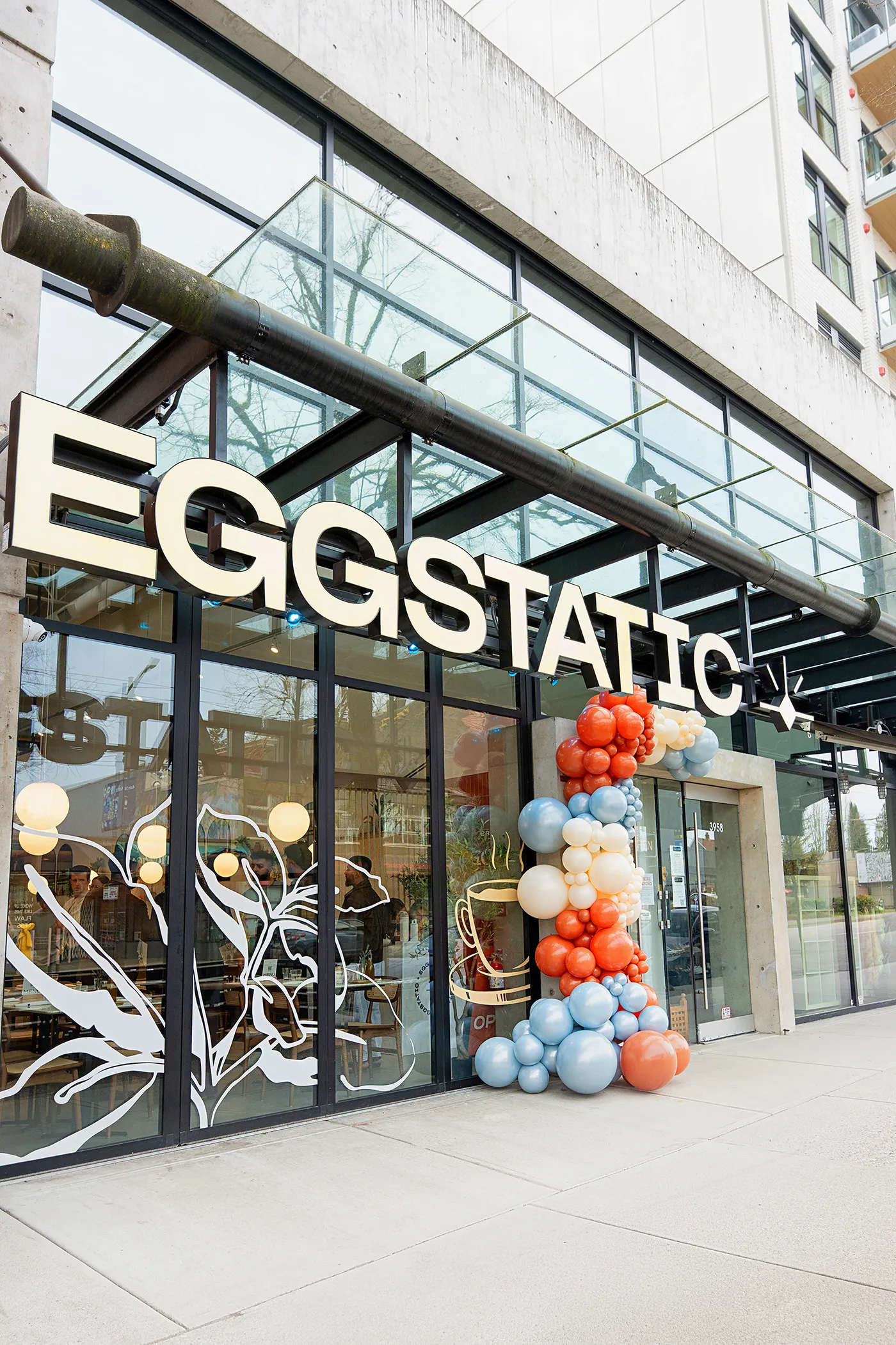 Eggstatic storefront exterior with celebration balloons