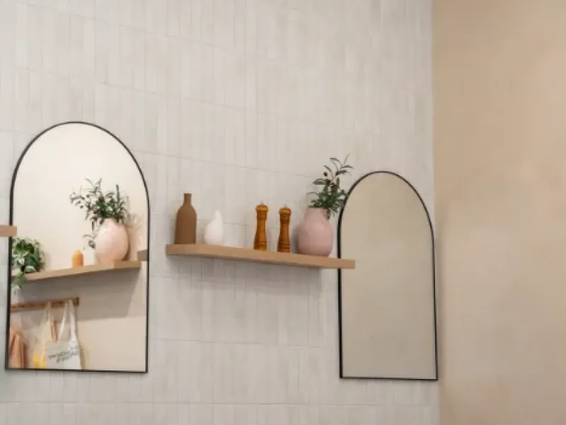 Tile wall with arched mirrors and styled shelf at Eggstatic Oakville on Winston Park Drive