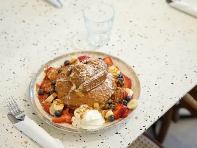 Stuffed croissant brunch plate with berries and whipped cream at Eggstatic Waterdown