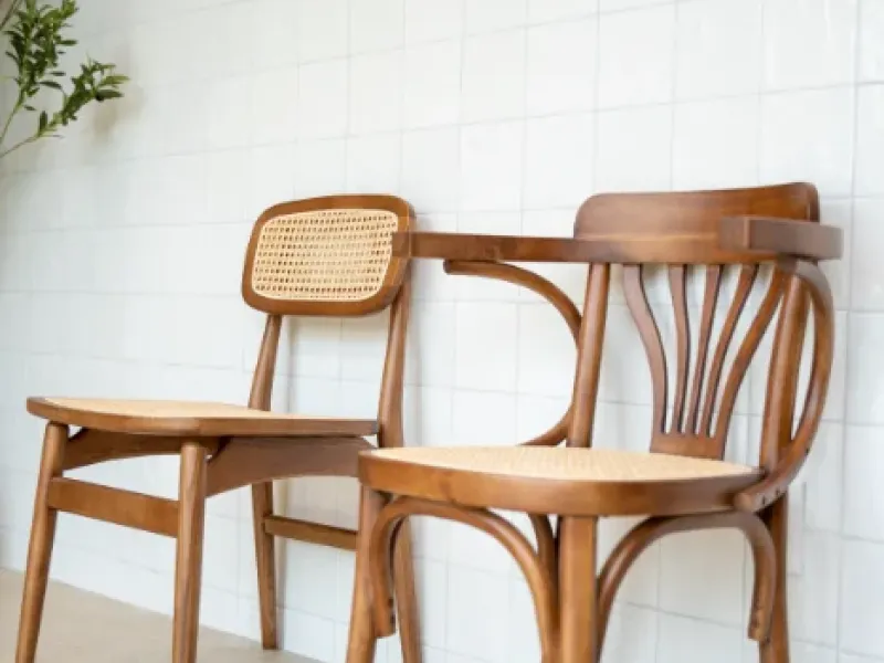 Bentwood chairs against tiled wall with coffee illustrations at Eggstatic London Ontario