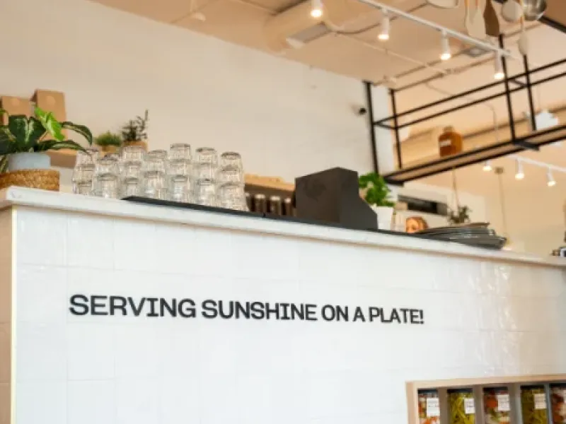 "Serving Sunshine on a Plate" service counter and hanging utensils at Eggstatic London Ontario