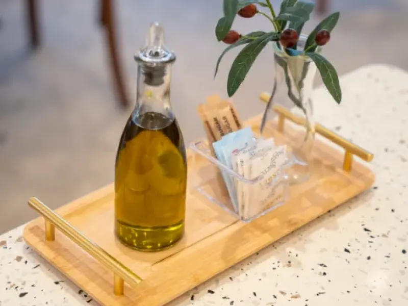 Olive-oil bottle and condiments caddy on a terrazzo table at Eggstatic Oakville