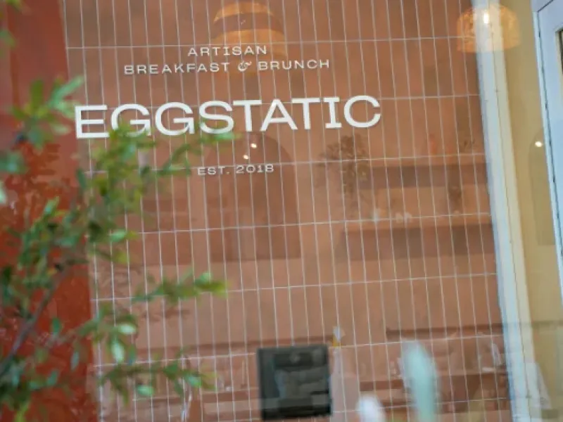 Eggstatic "Artisan Breakfast & Brunch — Est. 2018" terracotta-tile signage at Waterdown